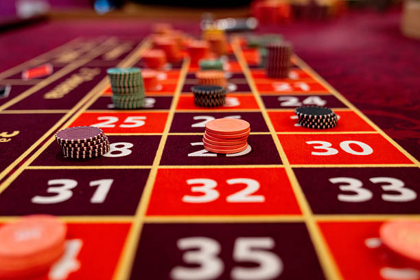 Live dealer at blackjack table with chips and cards visible
