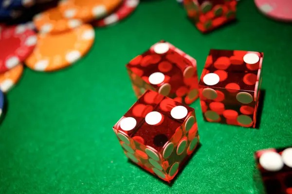 Three dice tumbling in Sic Bo table